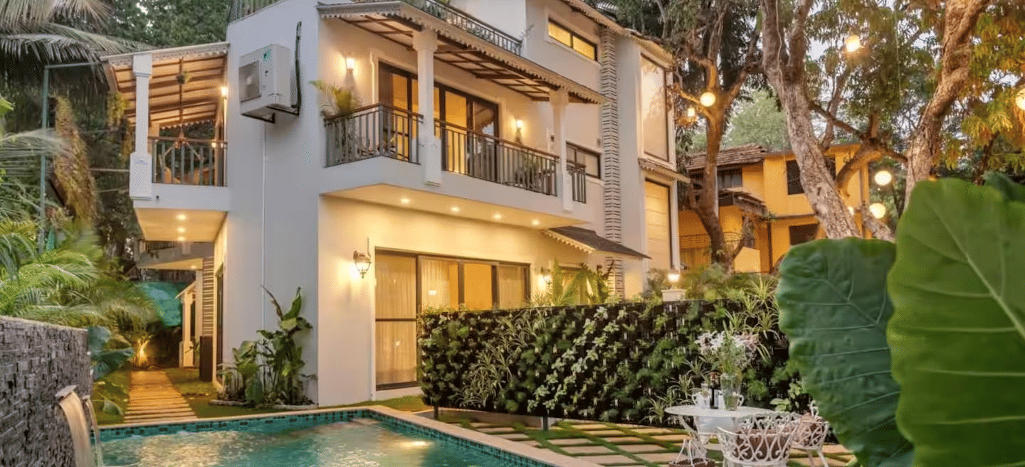 Exterior view of the villa with a pool surrounded by lush plants at Lime Tree Villa with Private Pool | Luxury Stay in Goa.